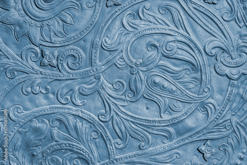 Fragment of an ancient coin with an ornate floral pattern