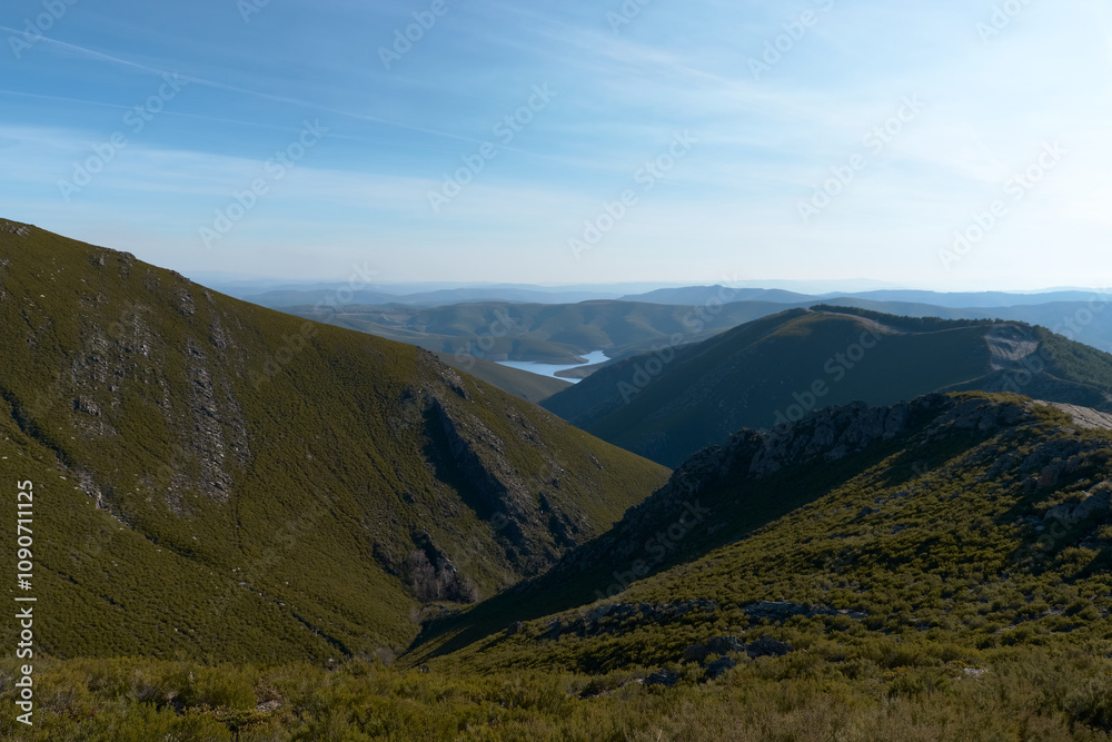 Fototapeta premium Scenic Valley with Distant River and Rolling Hills