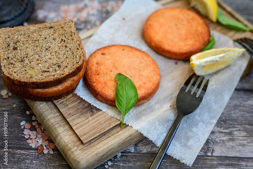  Fishburger.Homemade ketogenic  Salmon Burger with Tartar Sauce and  whole grain ketgenic bread. Healty  low carb high protein food photo