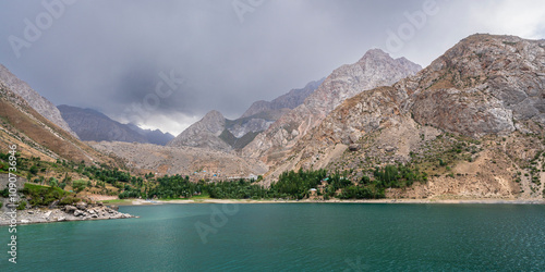 Scenic landscape panorama of Marguzor lake in Seven Lakes area aka Haft Kul under moody overcast sky, Fann mountains, Sughd, Tajikistan photo