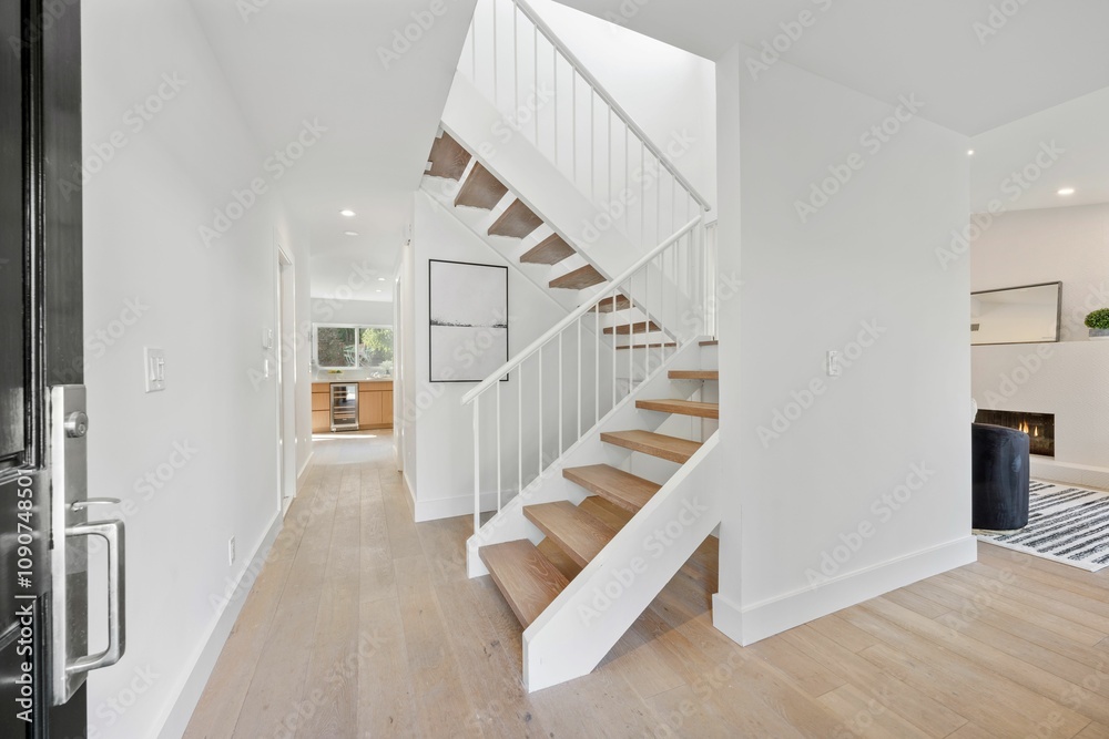 Obraz premium Modern hallway with wooden floor and staircase.