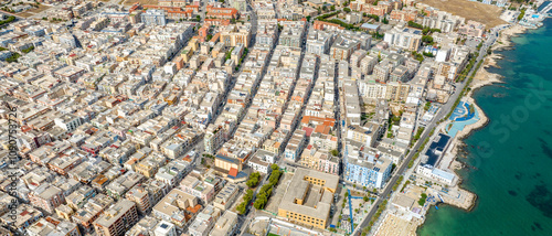 Aerial view of houses, buildings, apartments and roof of Manfredonia, in the province of Foggia, in Puglia, Italy. It is a town on Mediterranean sea. photo