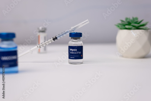 Mpox vaccine with syringe on top of it. pandemic, health and medical concept