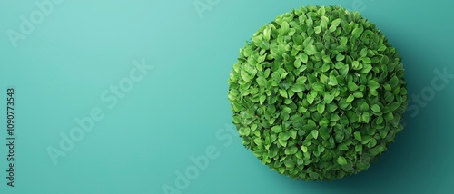 Green planet concept. Lush green sphere of foliage on a teal background, symbolizing nature and growth.