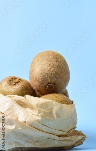 Vertical shot, kiwis in kraft paper bag.