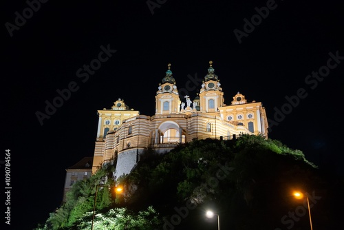 Melk Abbey castle in Austria, huge orange baroque building at night