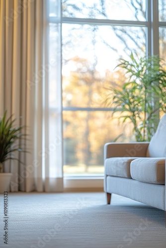 Cozy interior with sofa by window overlooking autumn scenery