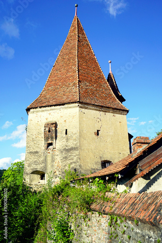 The Shoemaker's Tower (Turnul Cizmarilor) - a landmark in the Old Town of Sighisoara. Fortification architecture in Transylvania: a fortress tower built near the defensive walls of a medieval city. photo