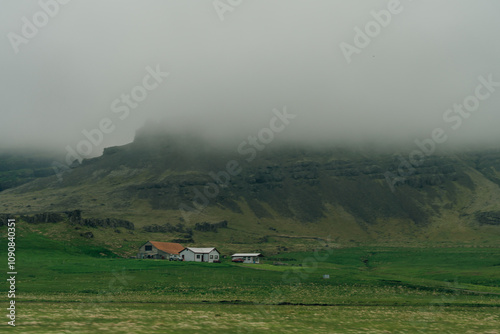 rural scene with grazing sheep,rustic farm buildings and a tranquil lake,capturing Iceland countryside charm. photo