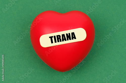 A vibrant red heart symbolizing love for Tirana, the capital city, surrounded by a playful green backdrop