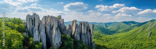 A stunning view of the majestic Seneca Rocks surrounded by lush green hills under a bright blue sky photo