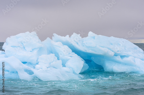 Blue Iceberg drifting in Hinlopen Strait, Spitsbergen Island, Svalbard archipelago, Norway photo