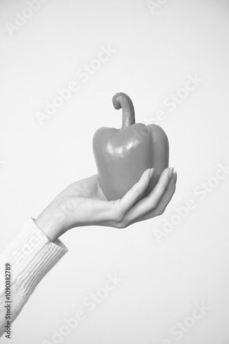 Person Holding an Orange Bell Pepper, Close View Background, Food Photography photo