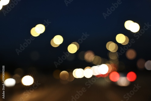 Blurred view of city street with lights at night