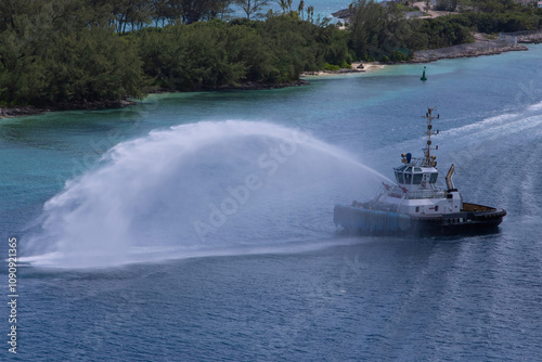 fire fighting tug boat spraying water in the harbour photo