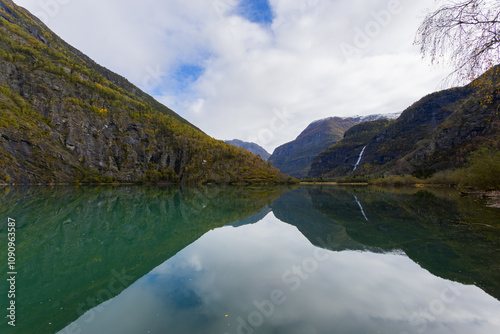 Autumn landscape in Skjolden, South Norway, with a calm lake reflecting the mountains and colorful foliage. photo