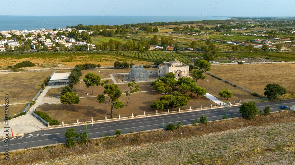 Aerial view of the Basilica of Santa Maria Maggiore di Siponto (Holy Virgin of Siponto). It's a church located near Manfredonia, in the province of Foggia, Puglia, Italy. In background is Adriatic sea Aerial view of the Basilica of Santa Maria Maggiore di Siponto (Holy Virgin of Siponto). It's a church located near Manfredonia, in the province of Foggia, Puglia, Italy. In background is Adriatic sea