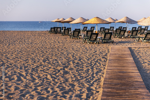 Sarigerme beach, Turkey. Aegean sea coast with umberellas photo