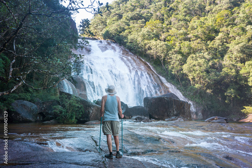 Hiker near waterfall photo