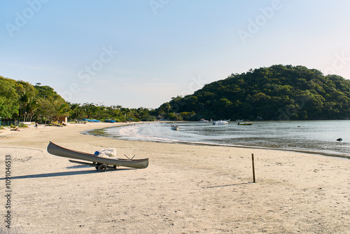 Serene Beach with Canoe and Lush Hills