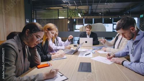 A group meeting is taking place within a modern office environment where diverse professionals are actively collaborating and sharing ideas to drive business development and success