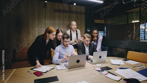 In a dynamic team environment, individuals collaborate in an engaging office, happy that the project passed, and planning strategically to achieve their business goals