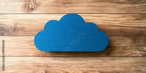 2025 business analytics concept. A blue wooden cloud shape resting on a wooden surface, evoking a simple, playful aesthetic.