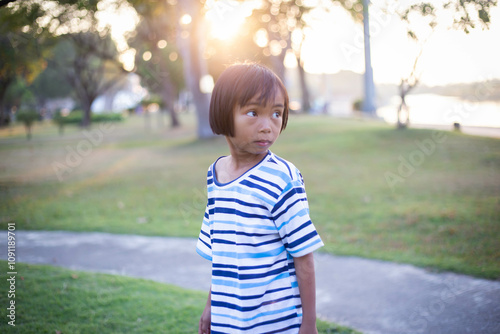 A sad little girl sitting alone outside photo