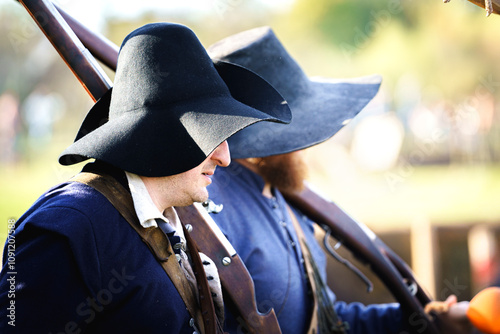 Historical medieval shooters from the militia with rifles and historical clothing Reenactor walking among the battlefield