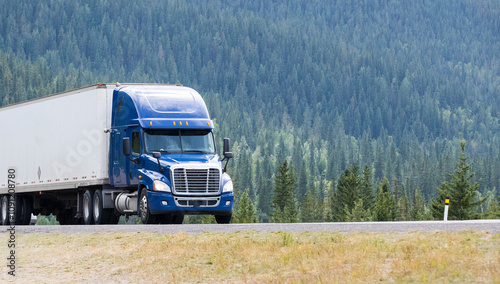 Heavy Cargo on the Road. A truck hauling freight along a highway. Taken in Alberta, Canada