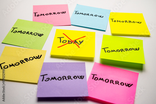 Colored card, with the word Today, crossed out, and next to it cards with the word Tomorrow. Procrastination and postponement.