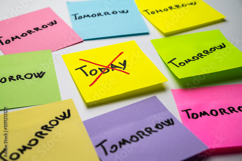 Colored card, with the word Today, crossed out, and next to it cards with the word Tomorrow. Procrastination and postponement.