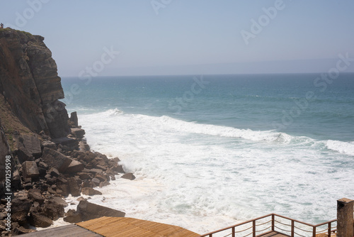 The crashing waves meet the rugged cliffs a breathtaking view of the ocean s power photo