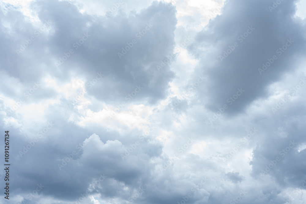 Fototapeta premium Fluffy white clouds drift across a vibrant blue sky