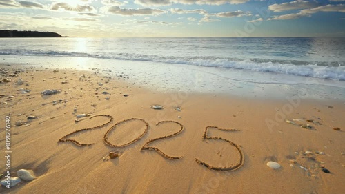 2025 year wash away on the sea sandy beach shore during sunset. Element of design.