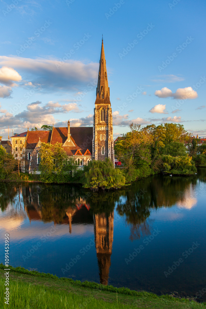 Fototapeta premium There is a reflection of gothic church in water by the lake