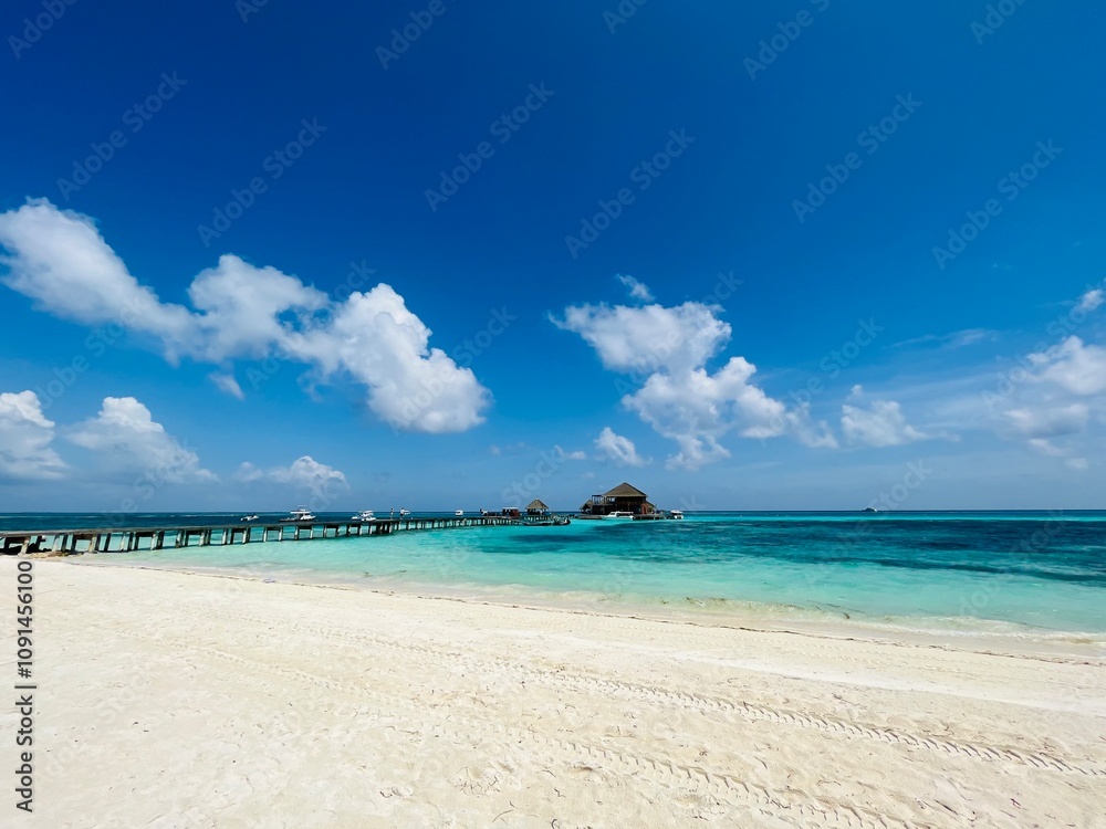 Fototapeta premium Long beach in resort under beautiful blue sky
