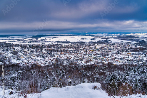 Obraz na płótnie A snowy landscape with a town in the distance. The sky is cloudy and the snow is covering the ground. Germany. w salonie