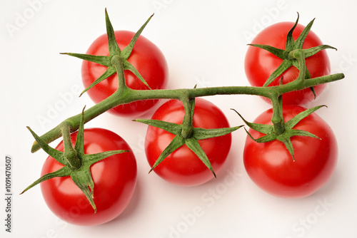 Photograph of red cherry tomatoes on the vine on white background. Top view. 