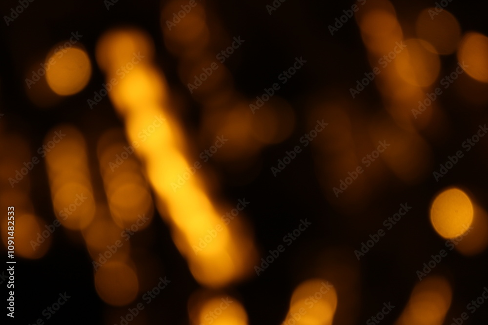 Fototapeta premium Red and fire orange bokeh on a black background, bokeh abstract background, modern abstract backdrop. Orange Christmas background, Xmas backdrop. Halloween scary concept, Halloween bokeh background 