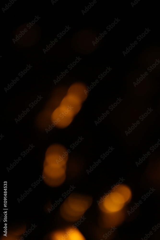 Fototapeta premium Red and fire orange bokeh on a black background, bokeh abstract background, modern abstract backdrop. Orange Christmas background, Xmas backdrop. Halloween scary concept, Halloween bokeh background 