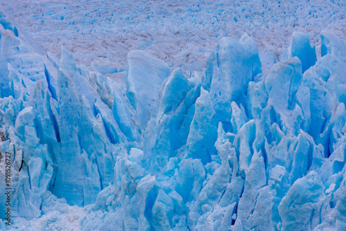 Perito Moreno Glacier blue ice searc in Argentina, Patagonia Los Glaciares national park. Blue ice of Patagonic glacier shuning on the sun, iceberg floating in lake at the bottom of a glacier photo