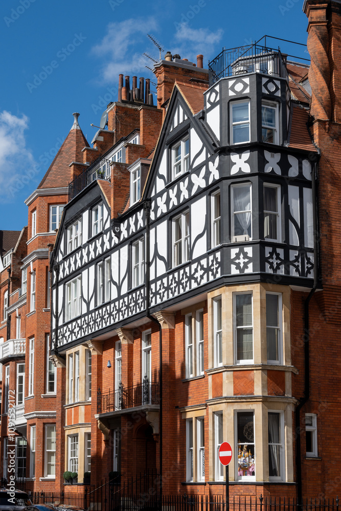Obraz premium Red bricks houses on Hans Crescent street in Royal Borough of Kensington and Chelsea, London, UK