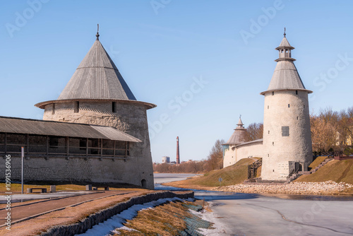 The Pskov Krom (Kremlin), an ancient castle in the old city of Pskov, western Russia, with fortified tower, citadel walls, and frozen river ice.
