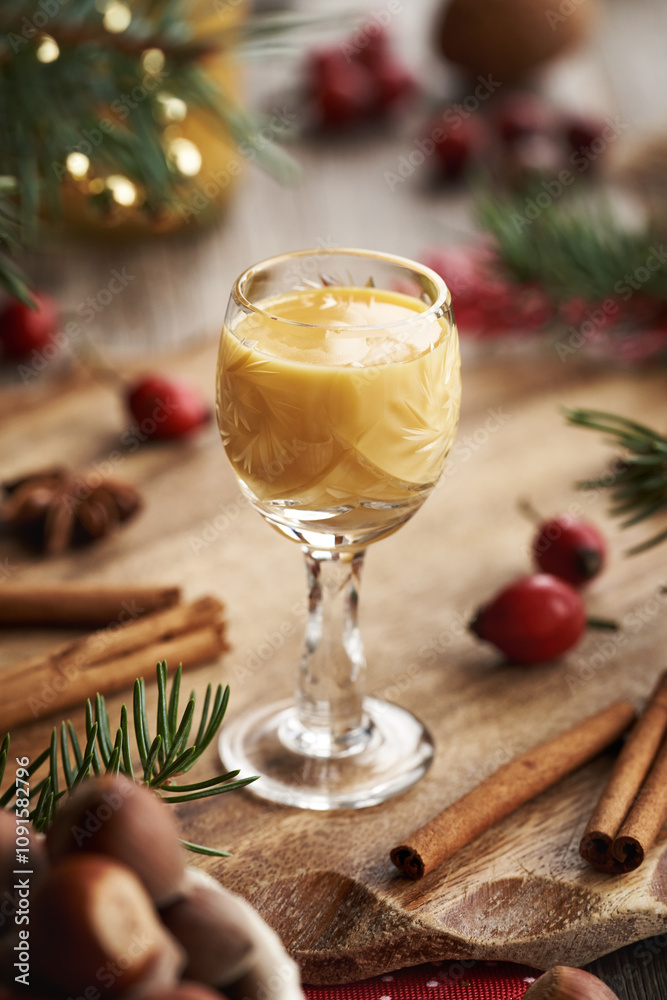 Obraz premium Two shot glasses of Eiercognac with spices and Christmas decoration