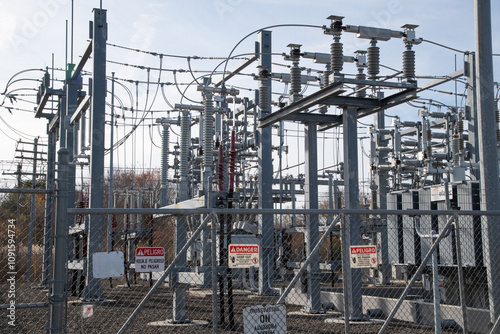 electric power station behind a chain link fence
