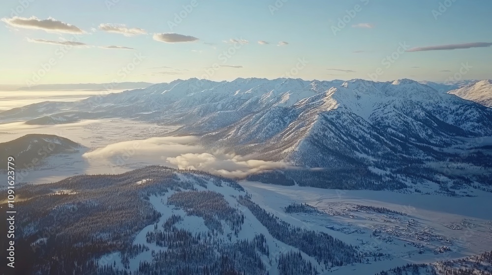 Obraz premium Snow-capped peaks rise majestically against a clear blue sky, while a subtle mist dances over a frozen lake at dawn, creating a serene winter landscape of breathtaking beauty