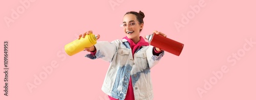 Young girl holding spray ca...