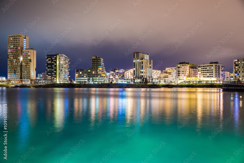 Fototapeta premium Vienna, Austria - December 27, 2022. New modern hipster quarter Asperner See Seestadt in Winter night