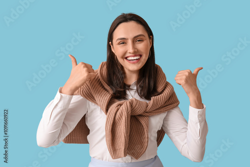 Smiling young woman showing...